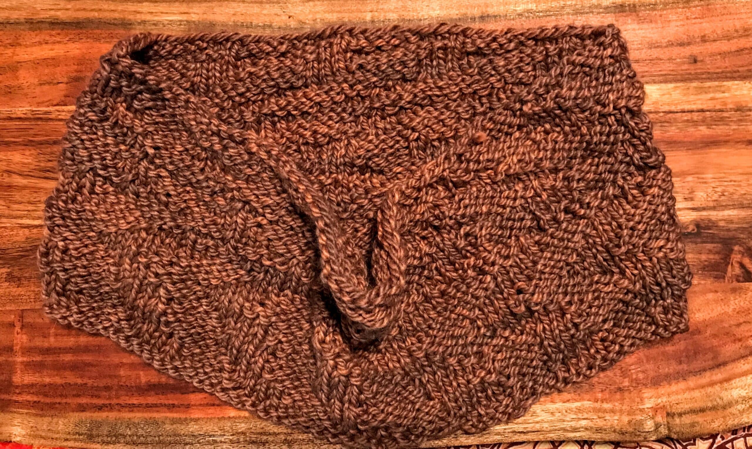 Wool cowl displayed on wood background