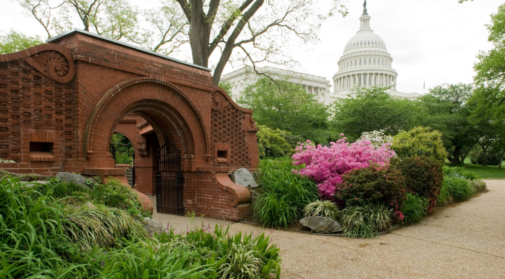 Summerhouse on the grounds of the US Capitol designed by Frederick Olmsted with azaleas in foreground and Capitol building in the background