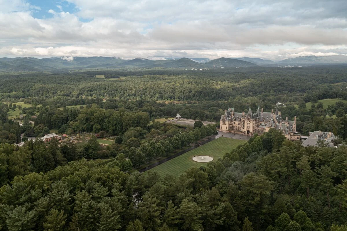 Arial view of the Biltmore mansion, the Conservatory, and forests