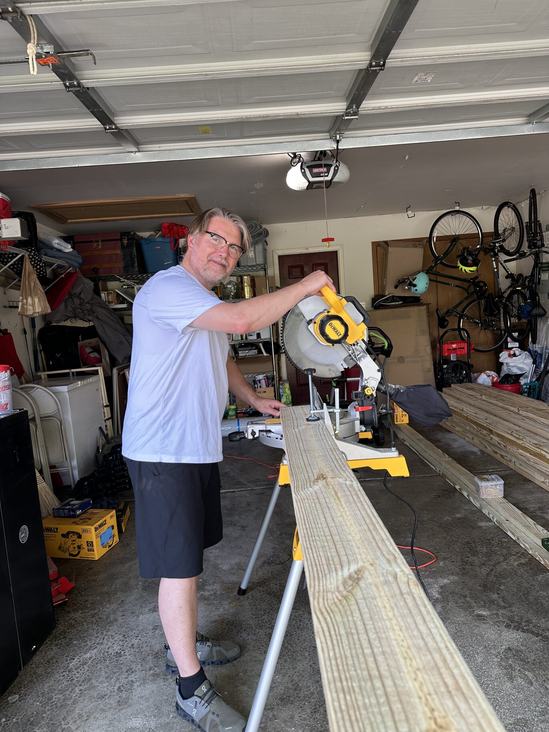 Rich using his new miter saw in the garage to cut floor joists