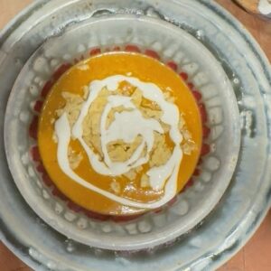 bowl of Tarascan-Style Sweet Potato Soup with crema and tortilla chips