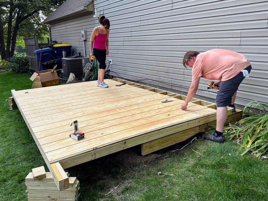 Rich and Katie installing the last full sheet of siding