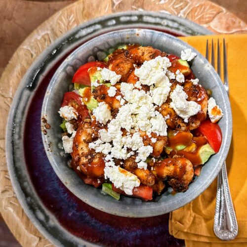 BBQ shrimp bowl topped with bbq sauce and crumbled feta