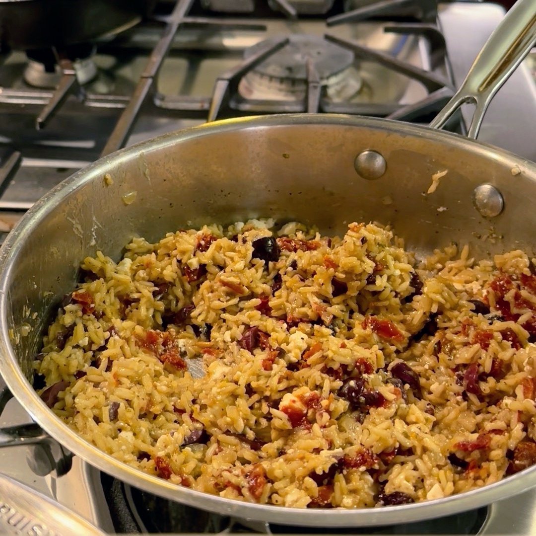 A skillet full of Mediterranean Rice with Sundried Tomatoes and Feta cheese