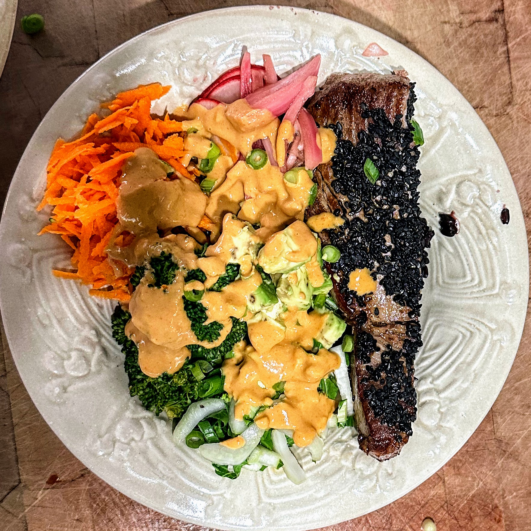 seared tuna poke bowl with dressing in a white pottery bowl