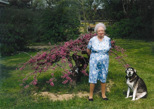 Connie Covey with Luke and her redbud tree