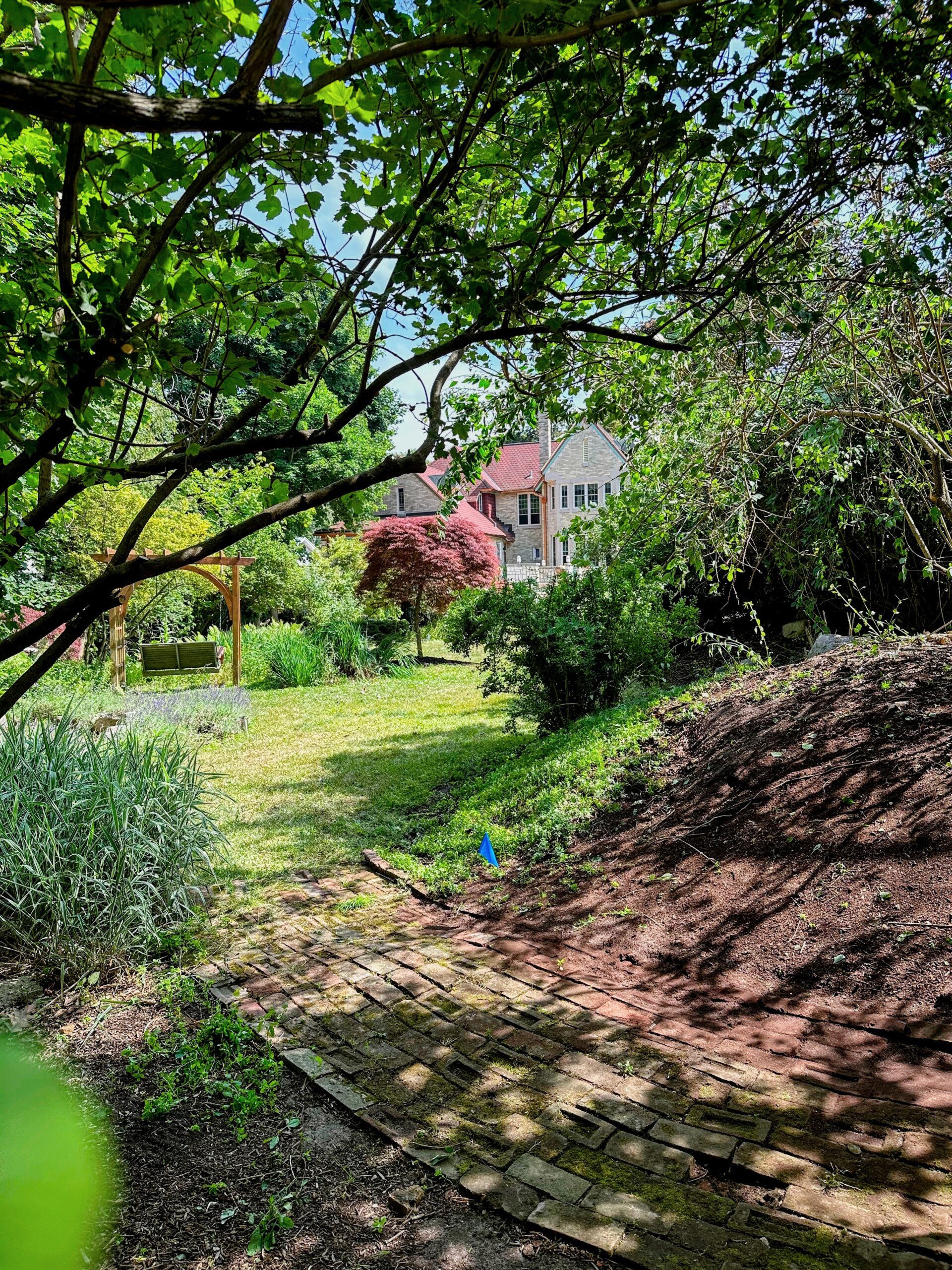 A room in a large yard created with a berm and plantings